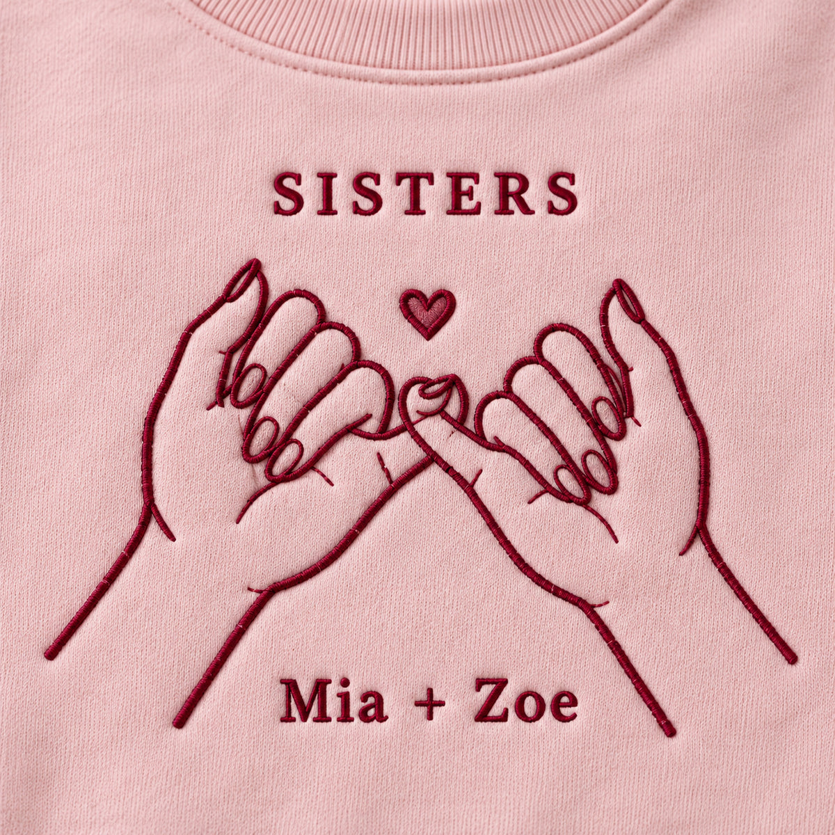 Sister Promise personalized Sister hands design; Light Pink sweatshirt mockup, embroidery detail; sample text SISTERS / Mia + Zoe