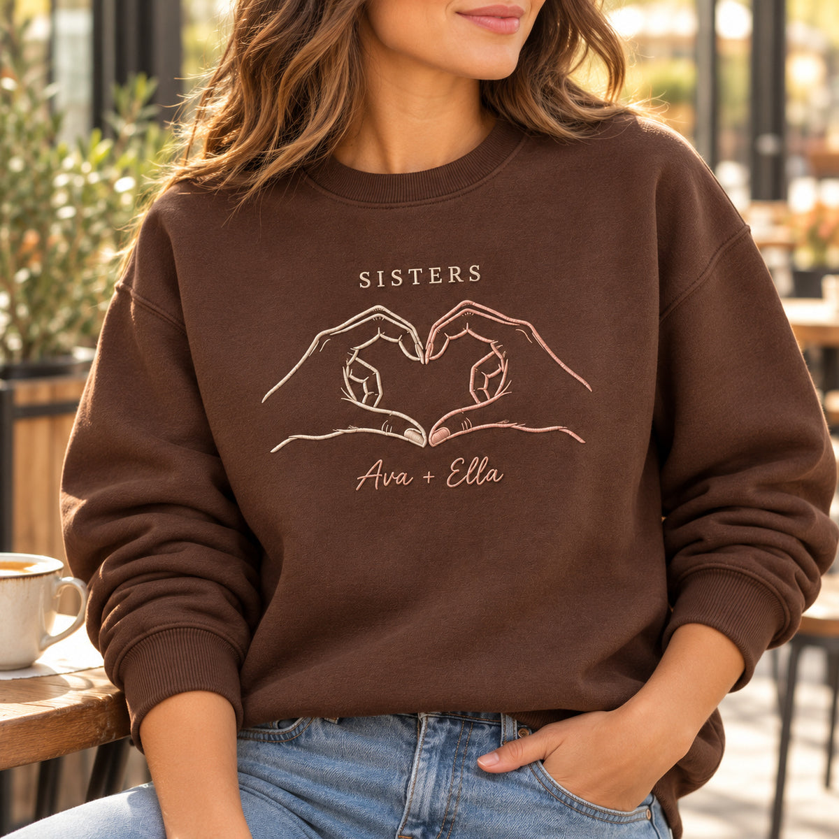 Shared Heart personalized Sister hands design; Chocolate sweatshirt mockup, lifestyle; sample text SISTERS / Ava + Ella