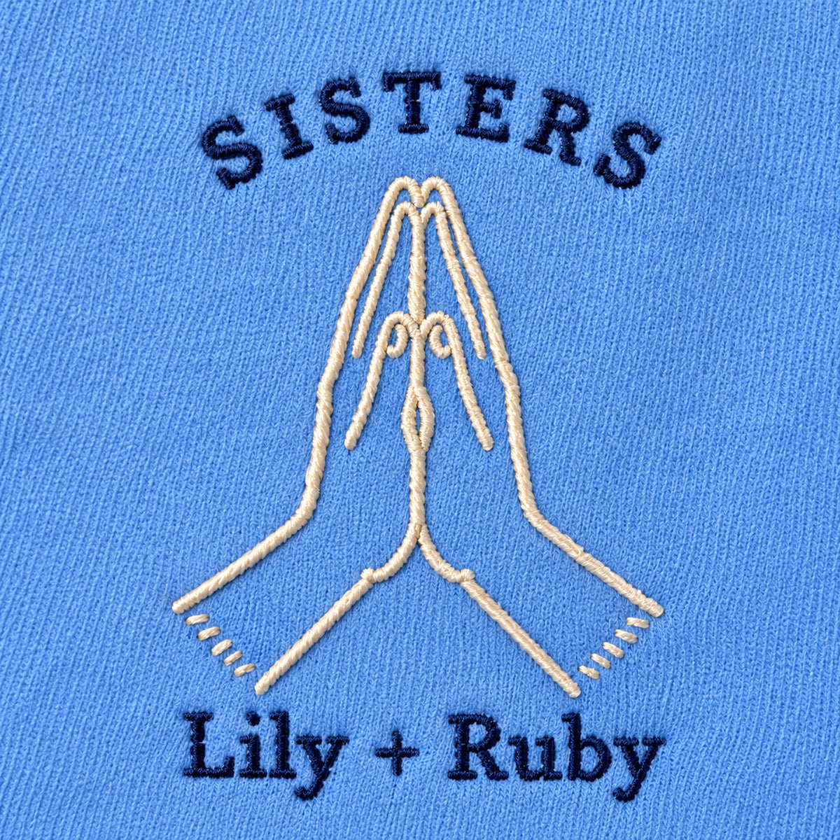 Sister High Five personalized Sister hands design; Carolina Blue sweatshirt mockup, embroidery detail; sample text SISTERS / Lily + Ruby