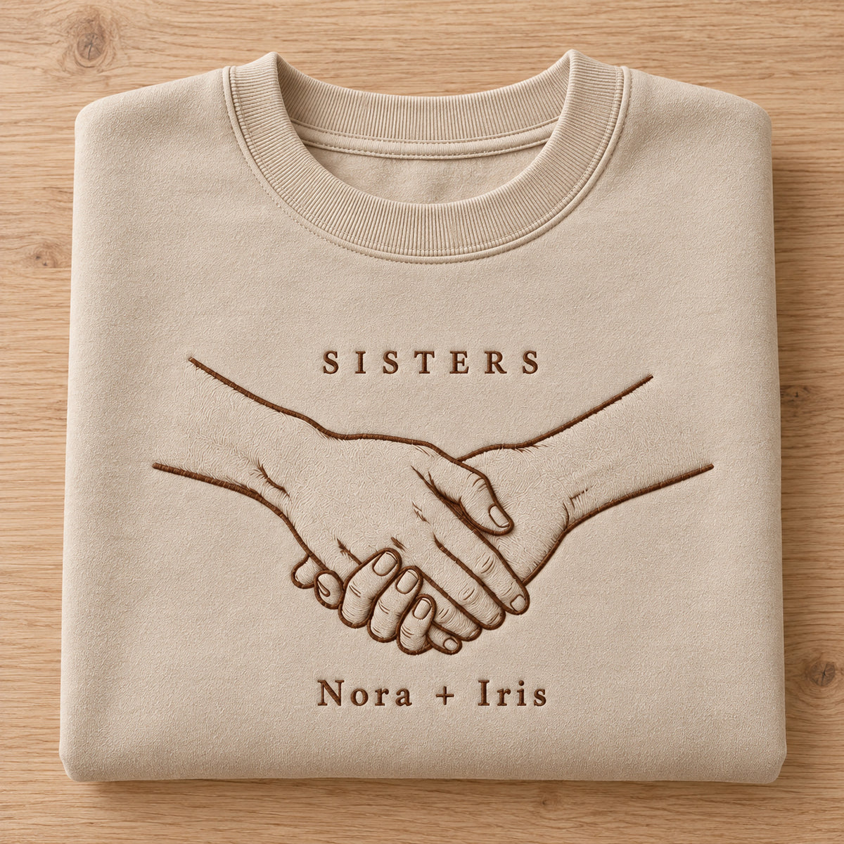 Hands Together personalized Sister hands design; Sand sweatshirt mockup, personalization detail; sample text SISTERS / Nora + Iris