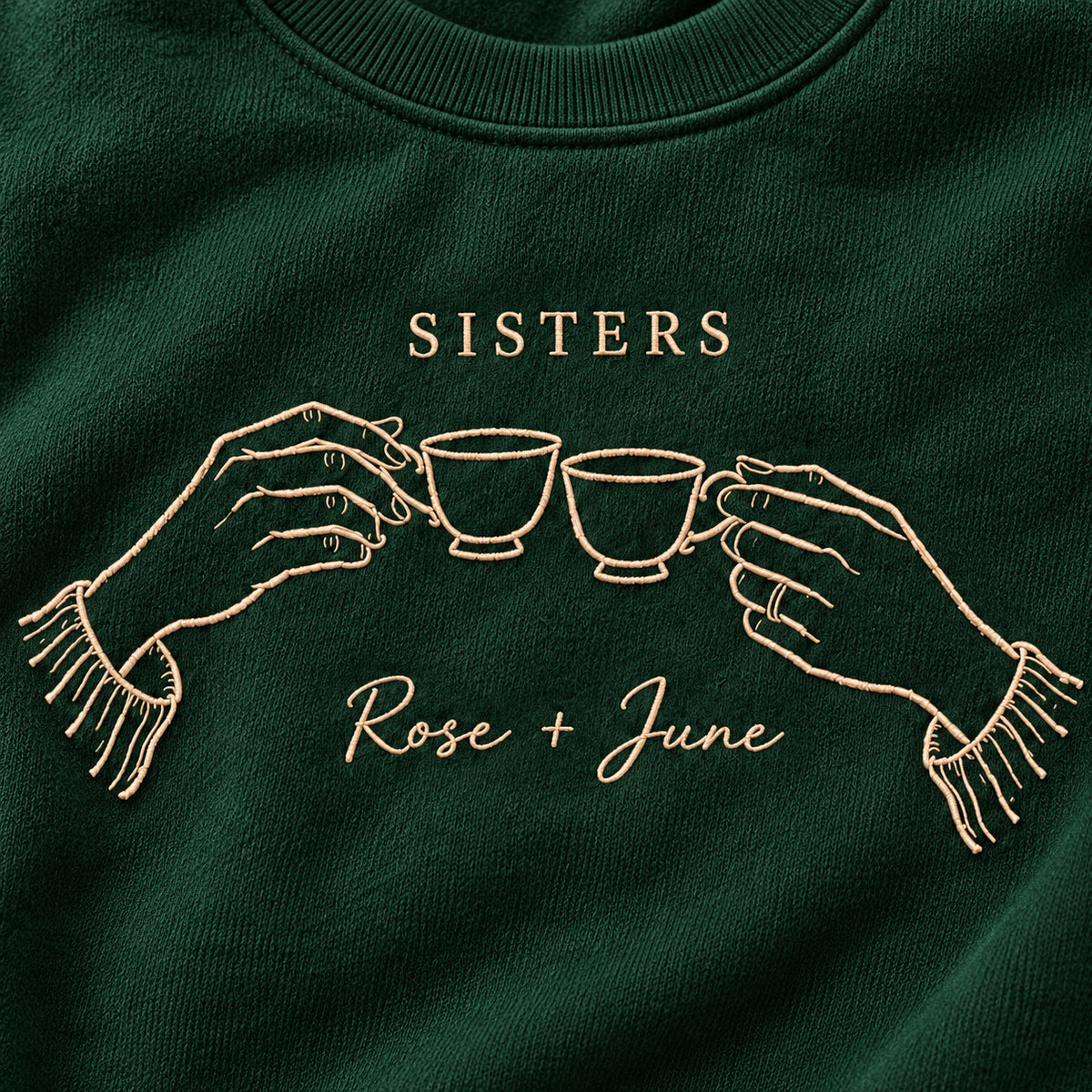 Sister Tea Ritual personalized Sister hands design; Forest Green sweatshirt mockup, embroidery detail; sample text SISTERS / Rose + June