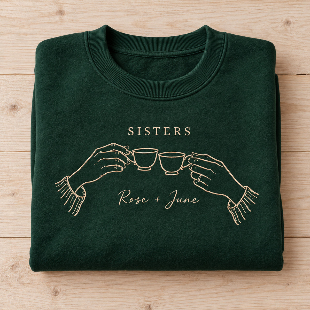 Sister Tea Ritual personalized Sister hands design; Forest Green sweatshirt mockup, personalization detail; sample text SISTERS / Rose + June
