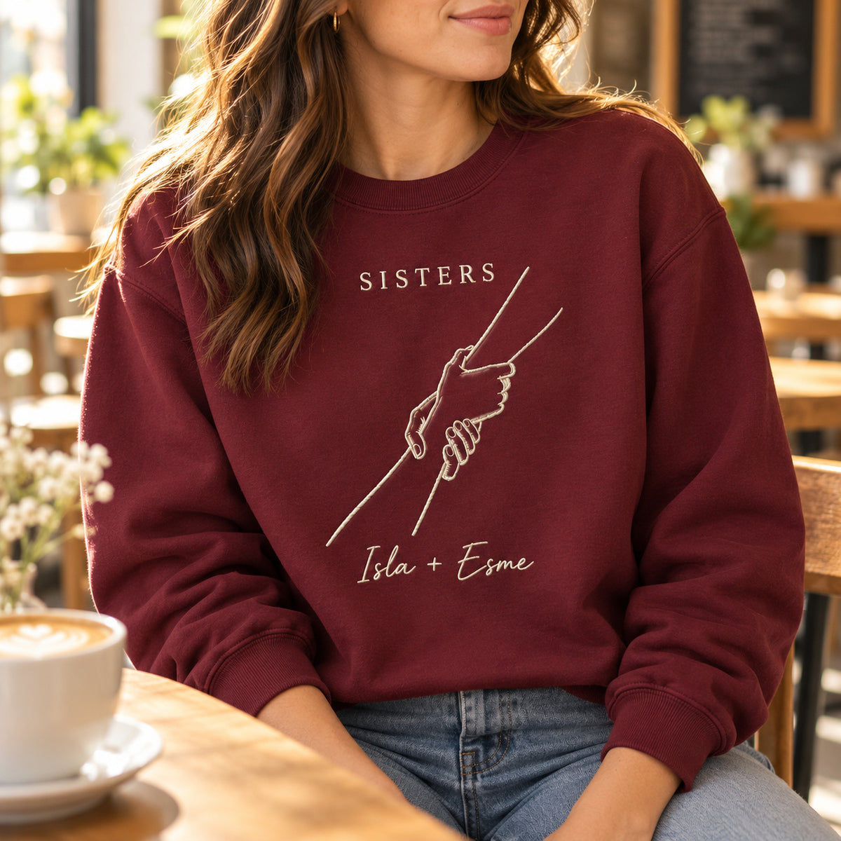 Helping Hand personalized Sister hands design; Maroon sweatshirt mockup, lifestyle; sample text SISTERS / Isla + Esme