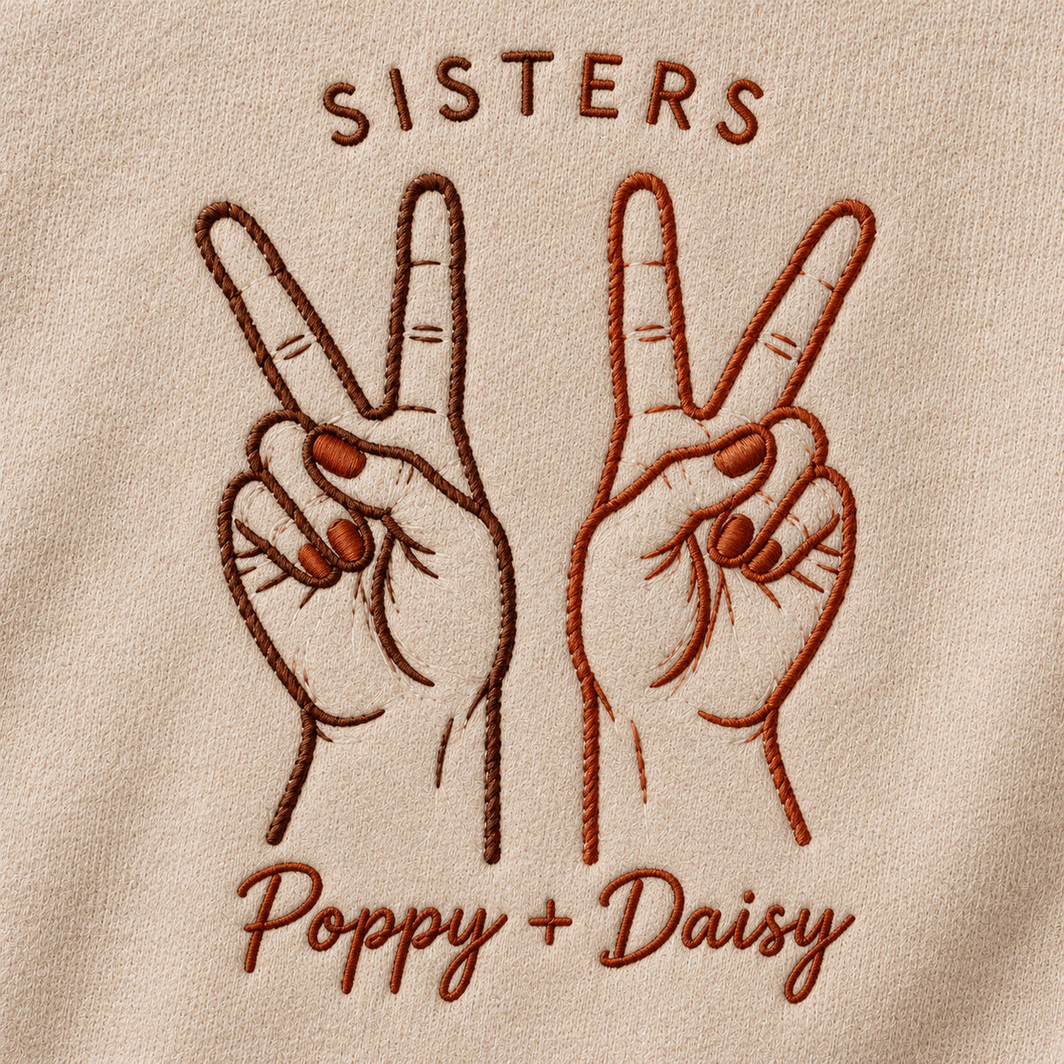 Peace Together personalized Sister hands design; Beige sweatshirt mockup, embroidery detail; sample text SISTERS / Poppy + Daisy
