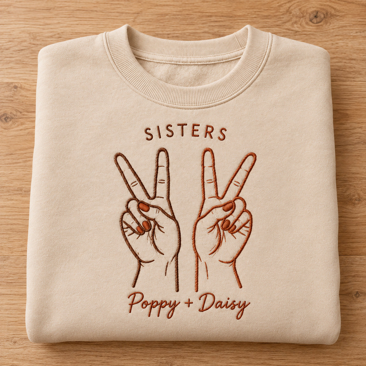 Peace Together personalized Sister hands design; Beige sweatshirt mockup, personalization detail; sample text SISTERS / Poppy + Daisy