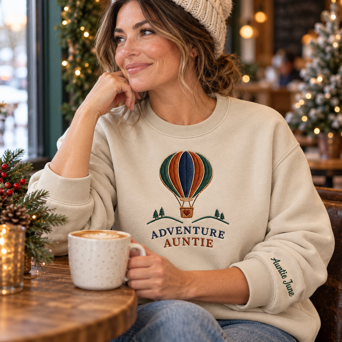 Adventure Auntie sweatshirt concept mockup featuring a hot-air balloon above small trees and hills, sample personalization Auntie June, lifestyle view
