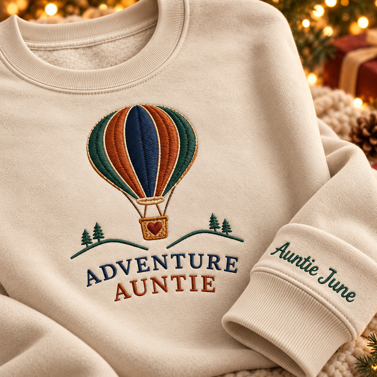 Adventure Auntie sweatshirt concept mockup featuring a hot-air balloon above small trees and hills, sample personalization Auntie June, personalization view