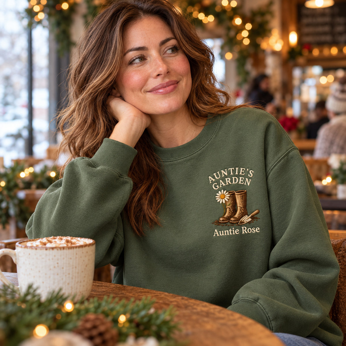 Auntie's Garden sweatshirt concept mockup featuring garden boots, a daisy and a hand trowel, sample personalization Auntie Rose, lifestyle view