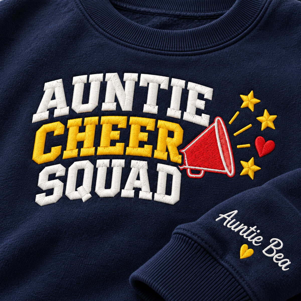 Auntie Cheer Squad sweatshirt concept mockup featuring a megaphone, stars and a small heart beside cheer lettering, sample personalization Auntie Bea, embroidery view