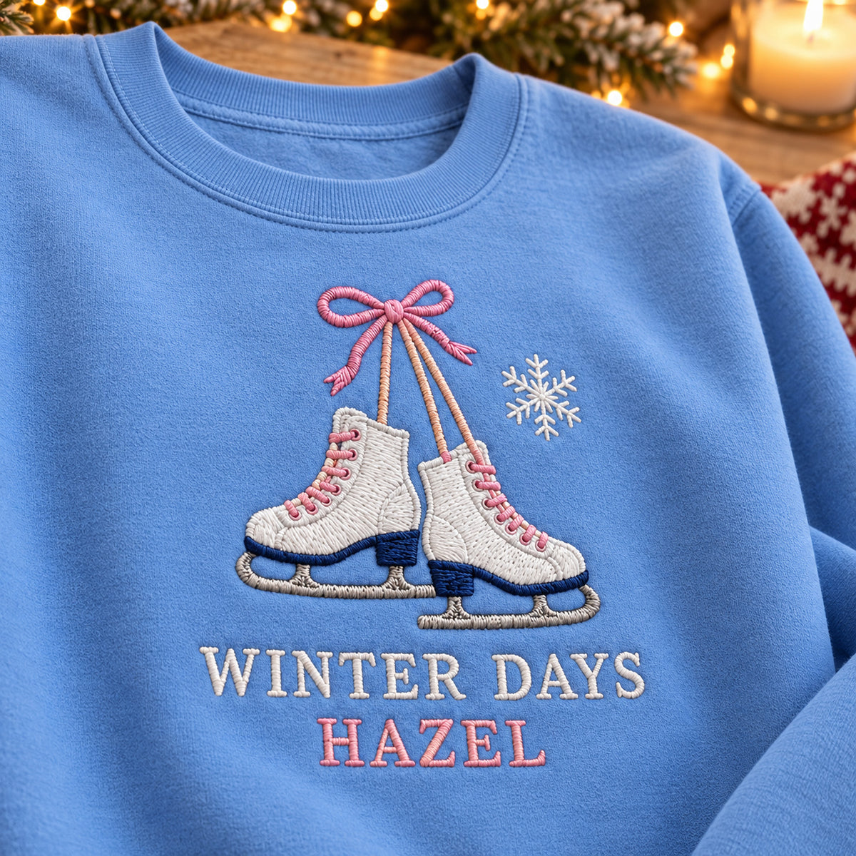 Winter Ice Skates sweatshirt concept mockup featuring a pair of ice skates tied with a pink bow, sample personalization HAZEL, personalization view