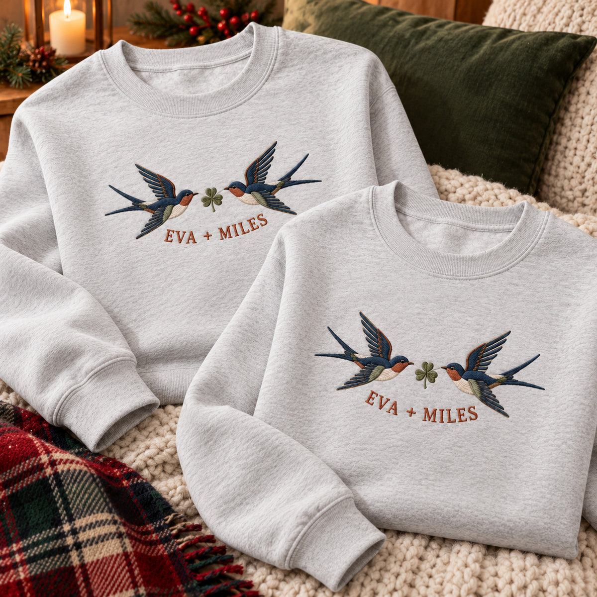 Returning Swallows sweatshirt concept mockup featuring two returning swallows with a leafy sprig, sample personalization EVA + MILES, personalization view