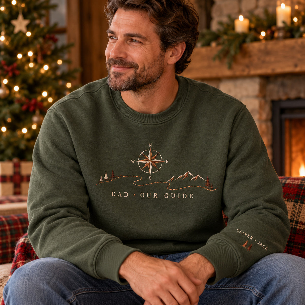 Dad's Compass sweatshirt concept mockup featuring a compass above a mountain landscape and winding path, sample personalization OLIVER + JACK, lifestyle view