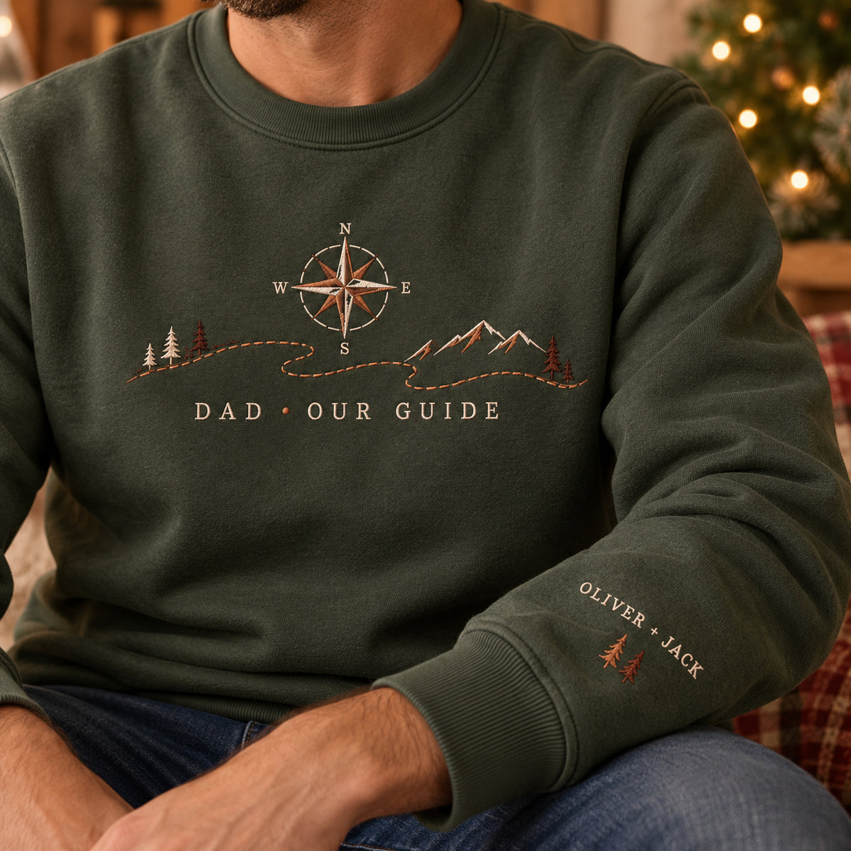 Dad's Compass sweatshirt concept mockup featuring a compass above a mountain landscape and winding path, sample personalization OLIVER + JACK, personalization view