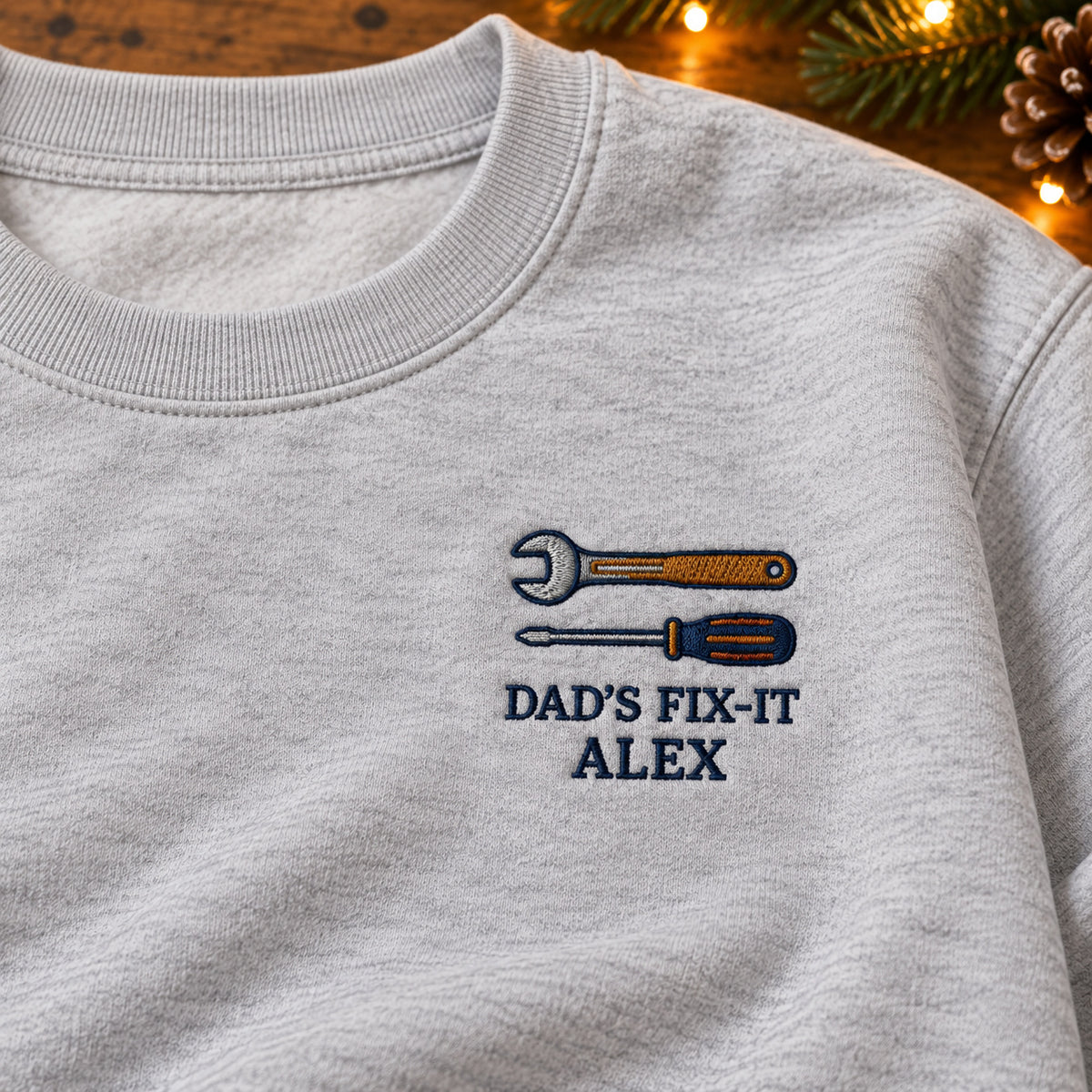 Dad's Fix-It sweatshirt concept mockup featuring a wrench and screwdriver, sample personalization ALEX, embroidery view