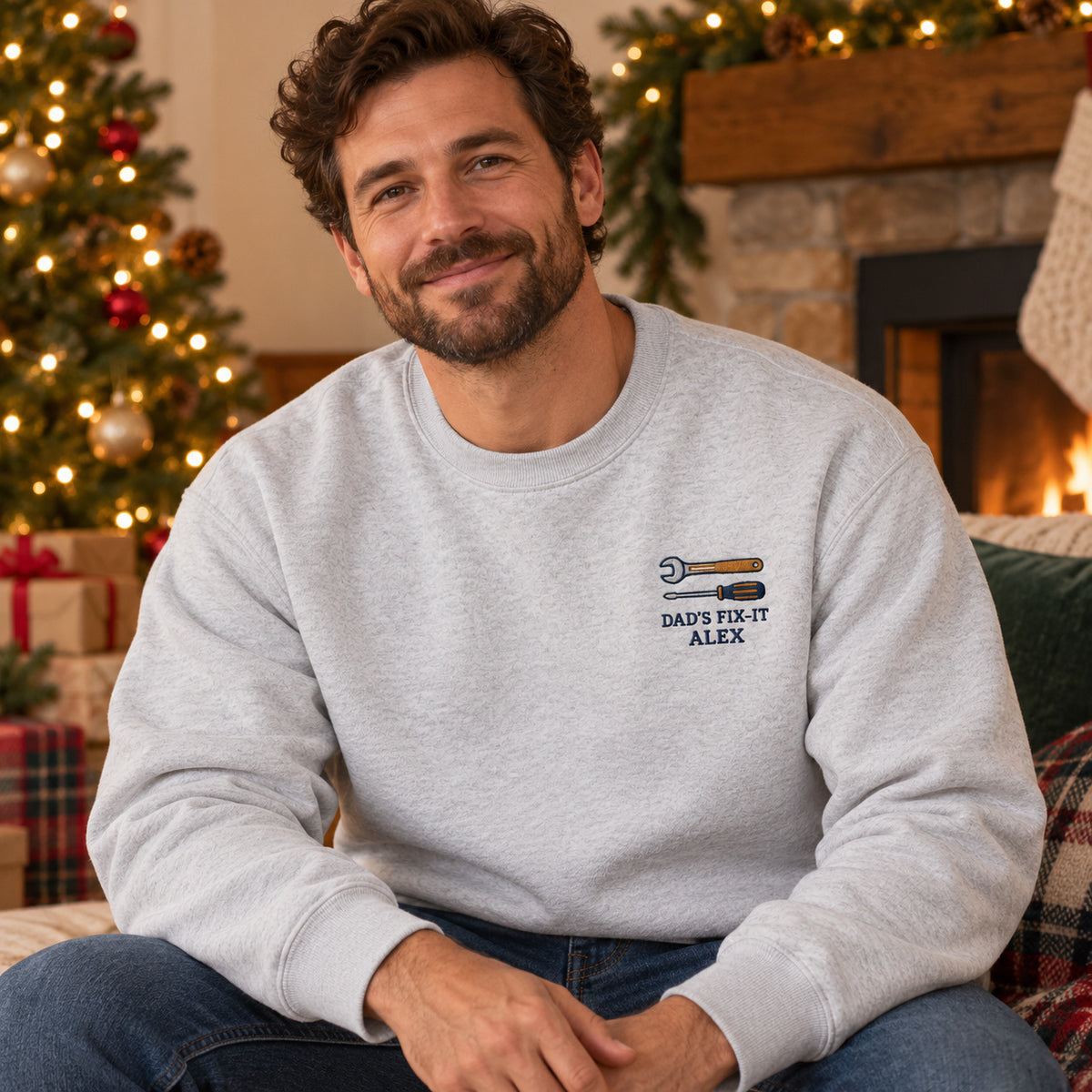 Dad's Fix-It sweatshirt concept mockup featuring a wrench and screwdriver, sample personalization ALEX, lifestyle view