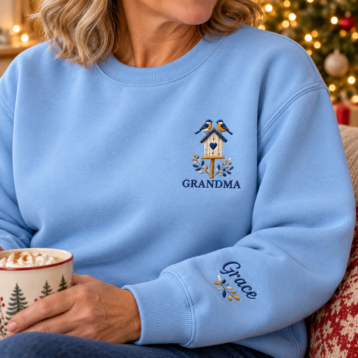 Grandma's Birdhouse sweatshirt concept mockup featuring two birds perched on a heart-window birdhouse, sample personalization Grace, personalization view