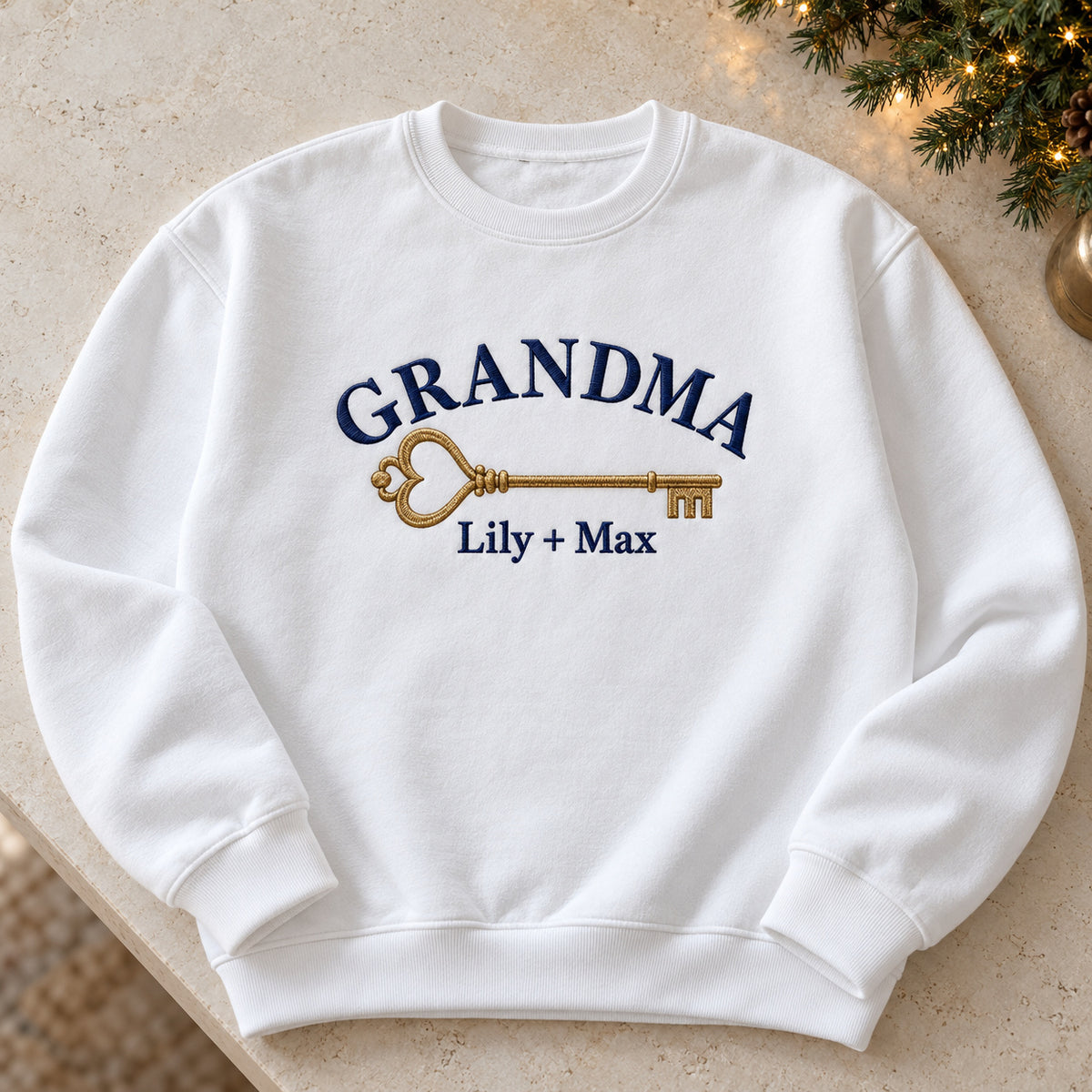 Grandma's House Key sweatshirt concept mockup featuring a vintage key with a heart-shaped bow, sample personalization Lily + Max, hero view