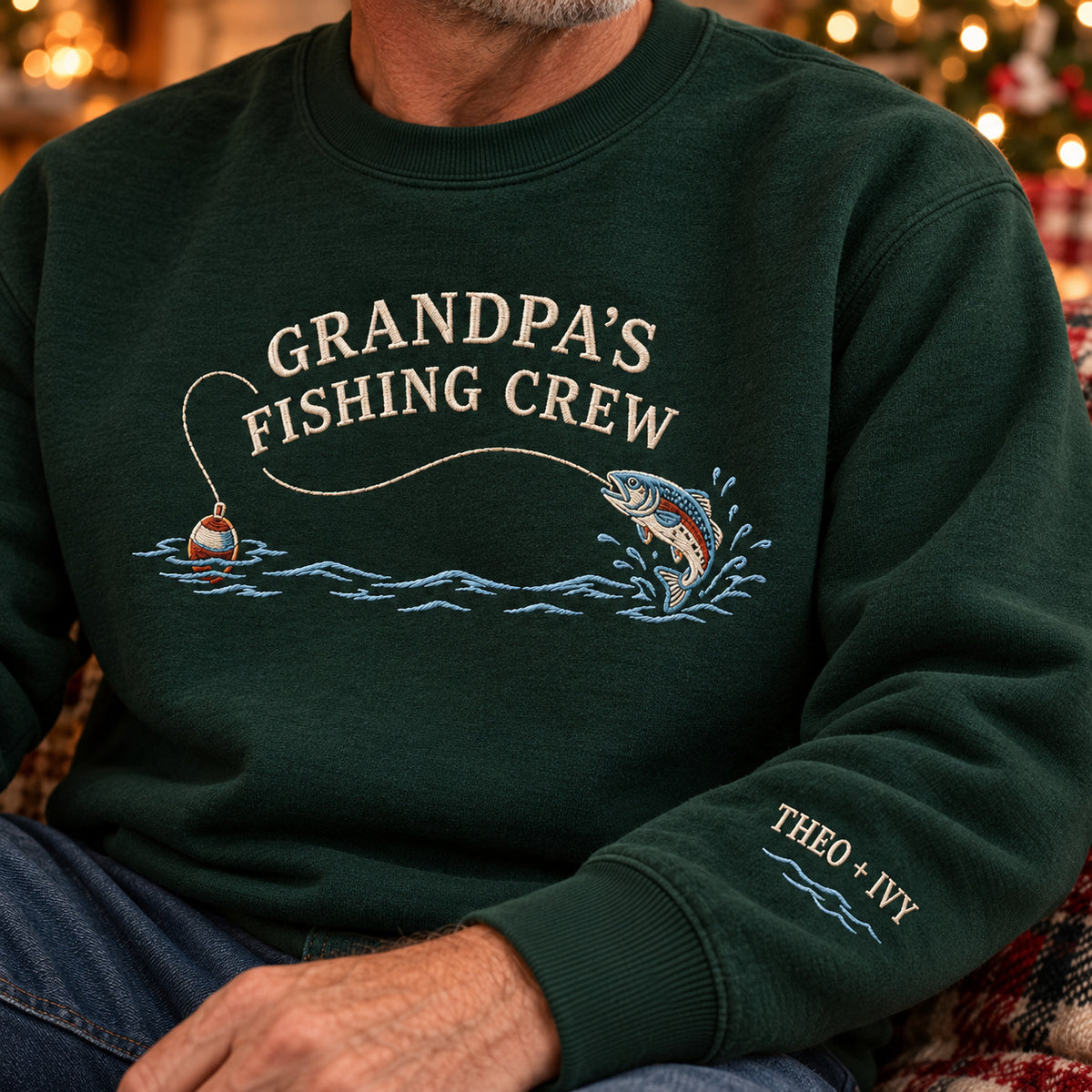 Grandpa's Fishing Crew sweatshirt concept mockup featuring a jumping fish, fishing float and flowing water, sample personalization THEO + IVY, personalization view