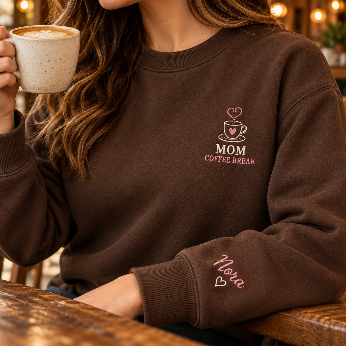 Mom's Coffee Break sweatshirt concept mockup featuring a coffee cup with a heart and heart-shaped steam, sample personalization Nora, personalization view