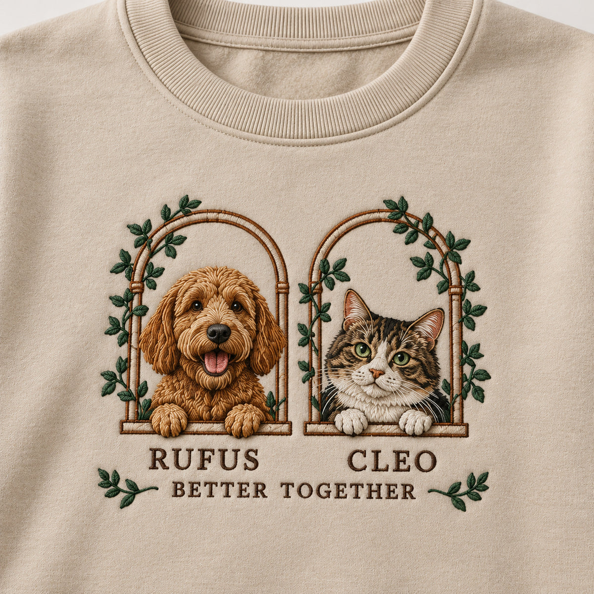 Two Little Windows sweatshirt concept mockup featuring a dog and cat in two leafy arched windows, sample personalization RUFUS     CLEO, personalization view