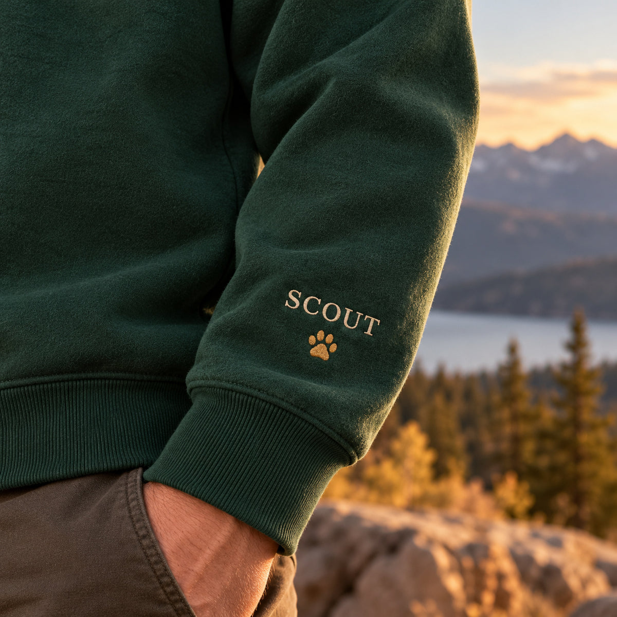 Trail Buddy sweatshirt concept mockup featuring a dog on a mountain trail with evergreen trees, sample personalization SCOUT, personalization view