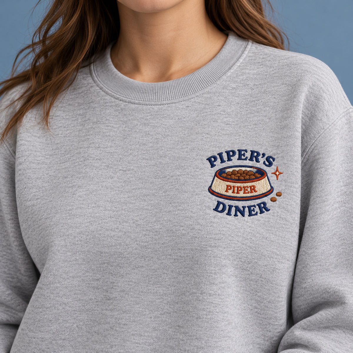 Pet Diner sweatshirt concept mockup featuring a personalized pet food bowl with diner lettering, sample personalization PIPER, personalization view