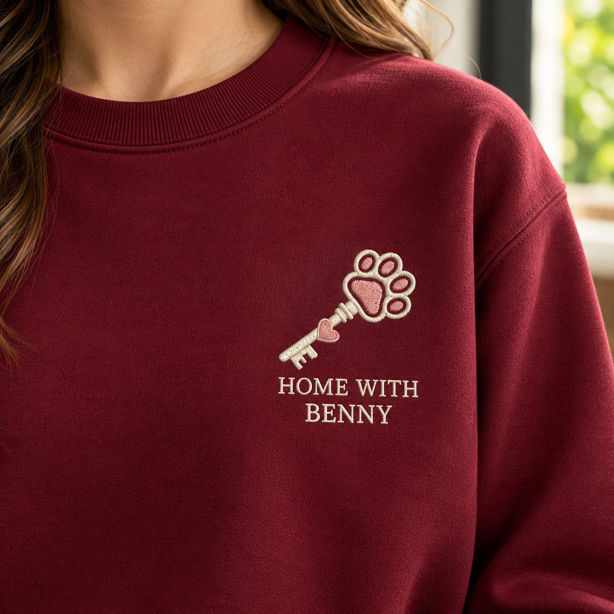 Home with My Pet sweatshirt concept mockup featuring a key with a paw-shaped bow, sample personalization BENNY, embroidery view