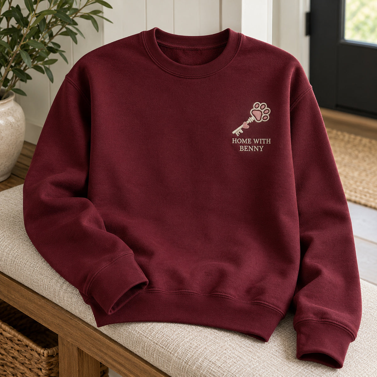 Home with My Pet sweatshirt concept mockup featuring a key with a paw-shaped bow, sample personalization BENNY, hero view