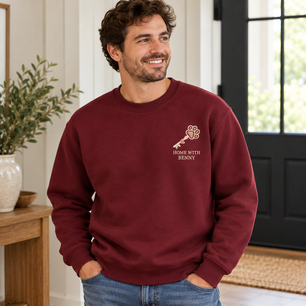 Home with My Pet sweatshirt concept mockup featuring a key with a paw-shaped bow, sample personalization BENNY, lifestyle view