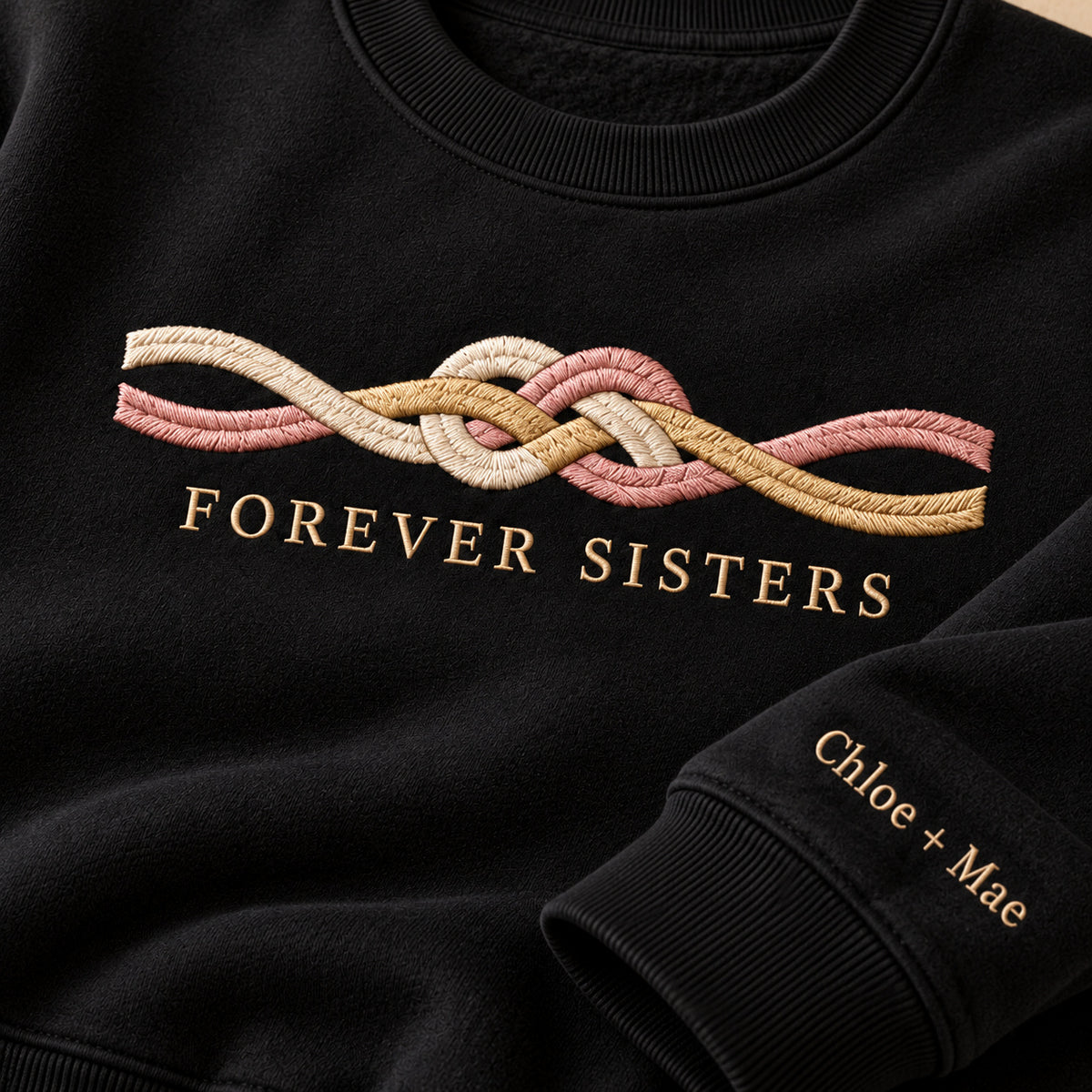 Forever Sisters Knot sweatshirt concept mockup featuring an intertwined friendship knot, sample personalization Chloe + Mae, embroidery view